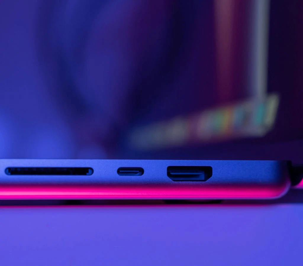 Person holding a slim and lightweight laptop with various ports