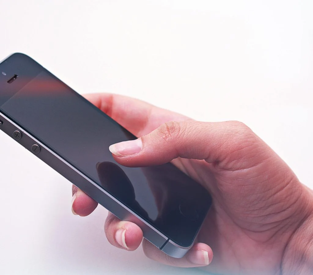 Person holding a smartphone and checking its performance