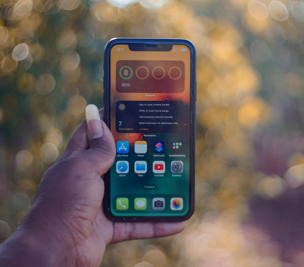 Person holding a smartphone and checking its screen