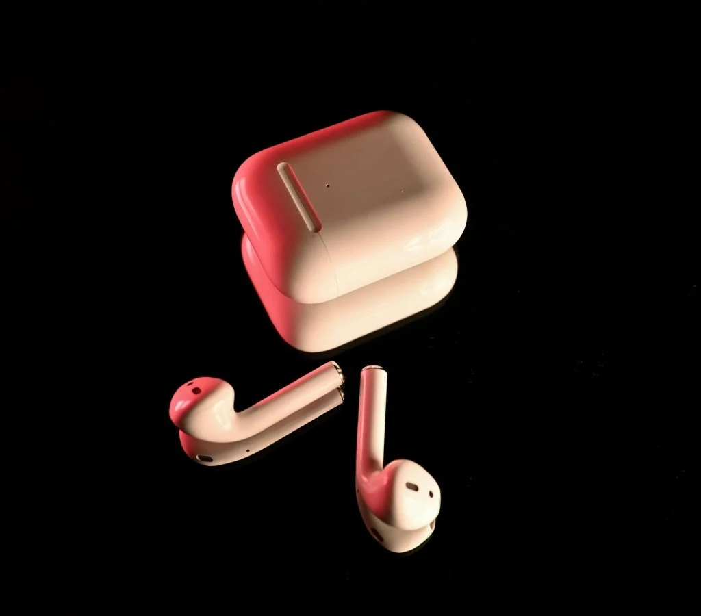 Woman happily listening to music with wireless earbuds that have noise cancellation