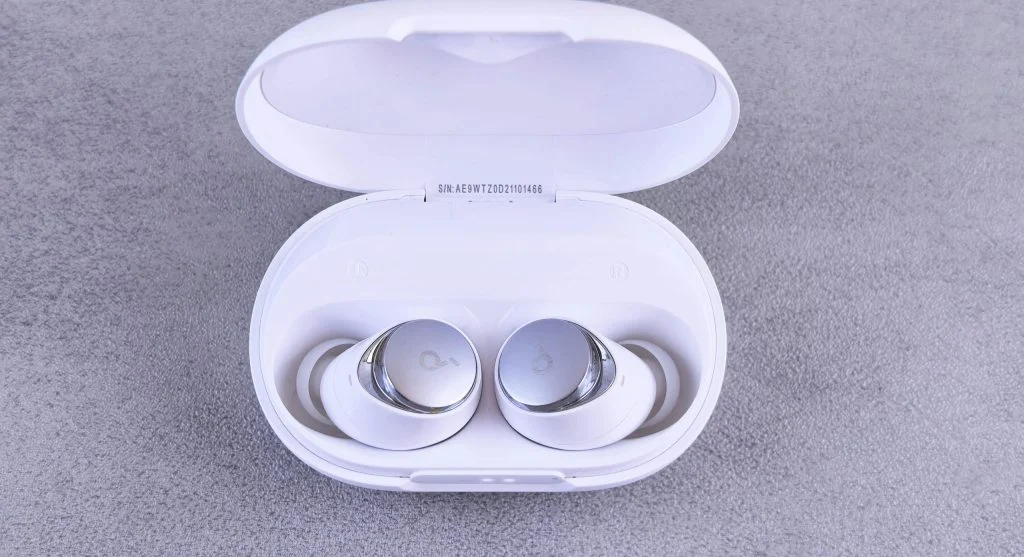 woman checking earbuds fit