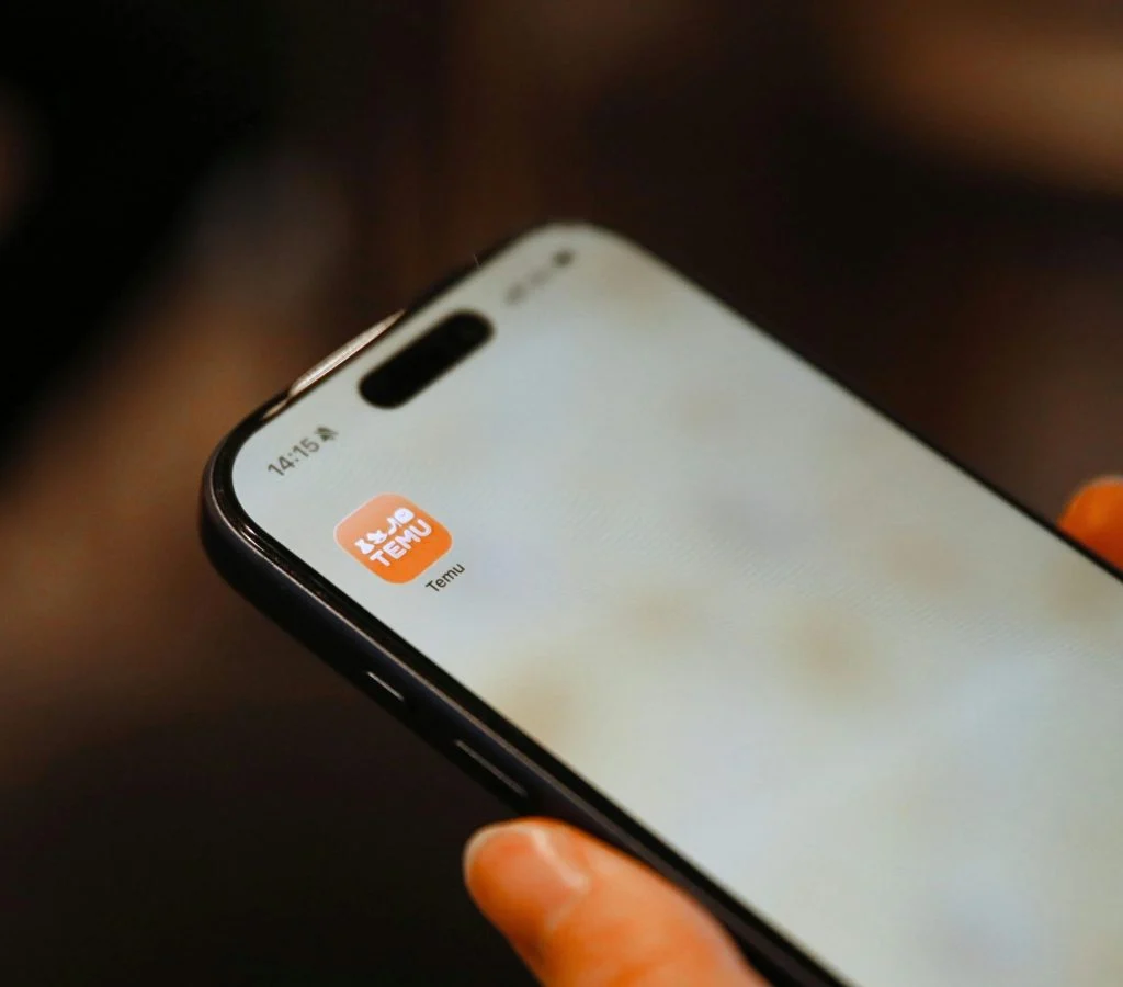 Person holding a smartphone and checking its camera
