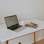 Laptop on a clean and organized desk with a workspace setup for better productivity