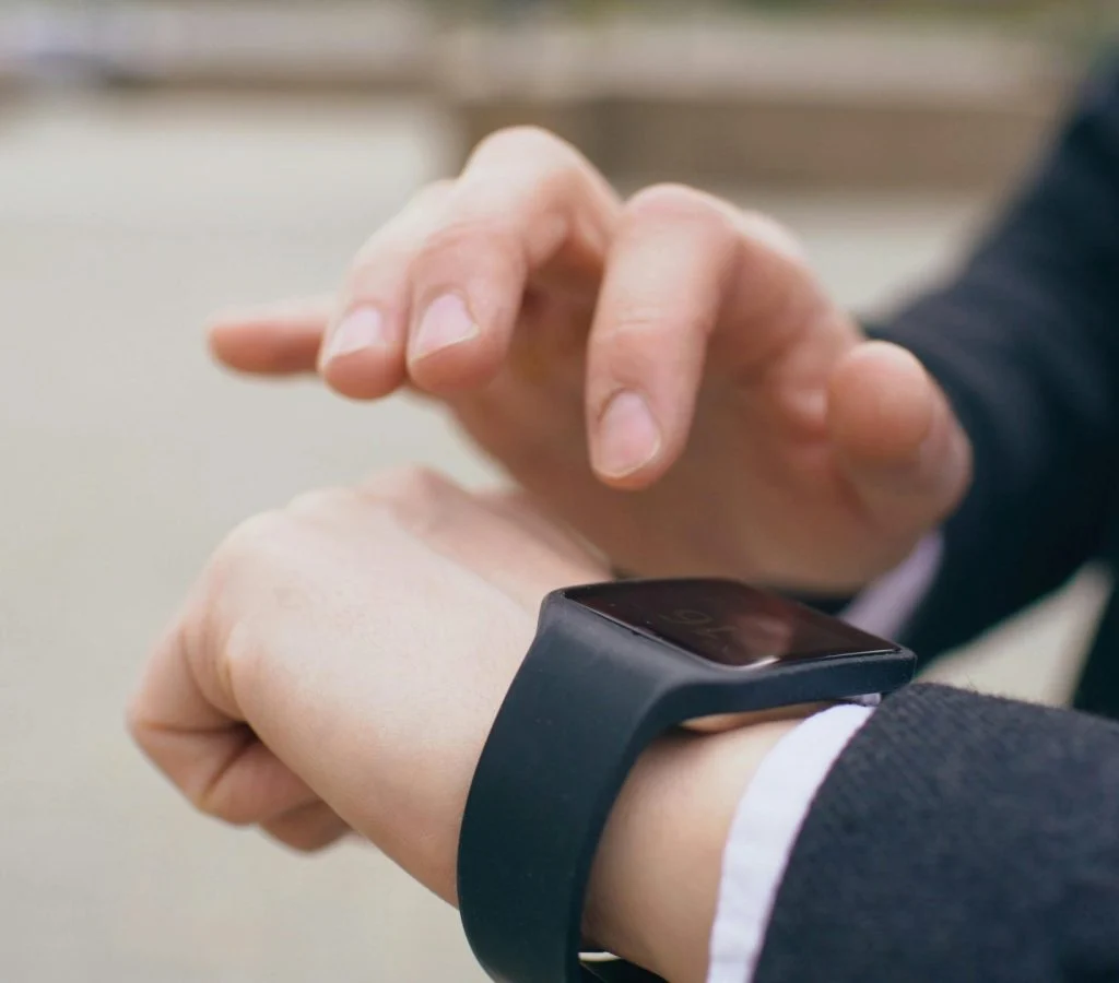 Person checking the comfort and fit of a smartwatch on their wrist