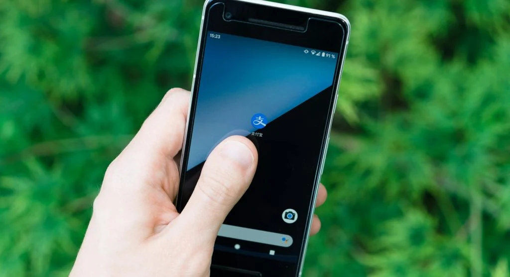 A person restarting their smartphone to fix crashing apps