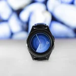 person holding several smartwatches with different designs and brands