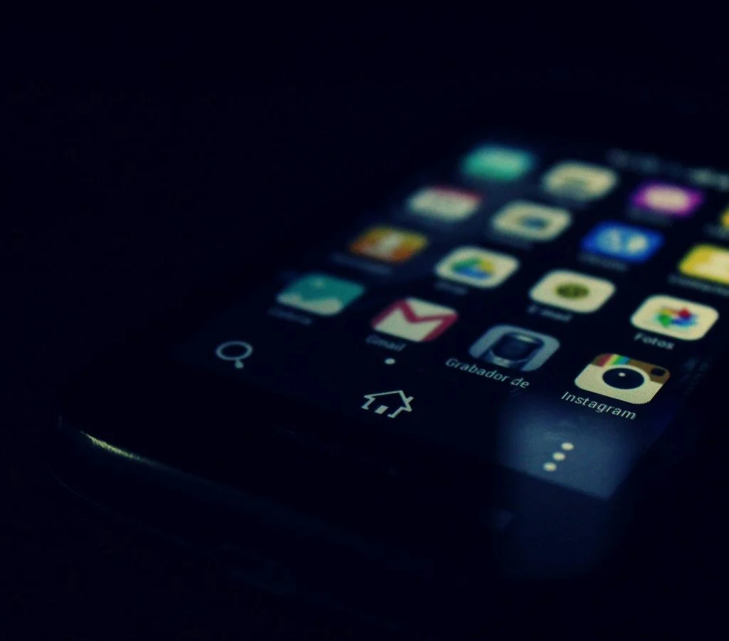 Illustration of a person surrounded by question marks and mobile phones, symbolizing confusion about smartphone facts